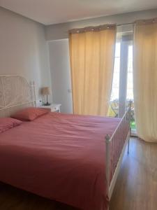 a bedroom with a large bed with a red blanket at Apartamento centro 3 habitaciones in Almería