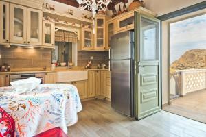 a kitchen with a refrigerator and a table at Ambeli house Arkasa in Arkasa