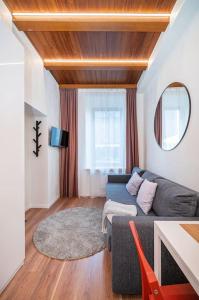 a living room with a couch and a table at Cozy studio in the city center in Vilnius