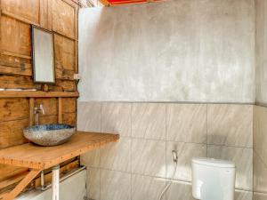 a bathroom with a sink and a toilet at Mimpi Bungalow in Gili Meno +27 photos