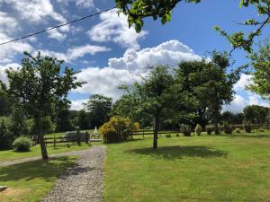 a park with trees and a gravel path at The Stable in Sourdeval