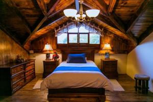 a bedroom with a bed and a large window at Hosteria Rumipamba De Las Rosas in San Miguel de Salcedo