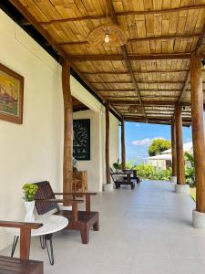 a pavilion with benches and tables and a chalkboard at Harsa Eco Luxury Camp in Gobleg