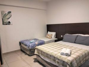 a bedroom with two beds in a room at Marina Heights Home Suite Teluk Batik in Lumut