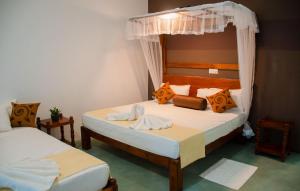 Postel nebo postele na pokoji v ubytování Sigiriya Cottage