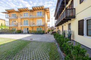 an apartment building with a courtyard in front of it at Residence Desiree in Riva del Garda