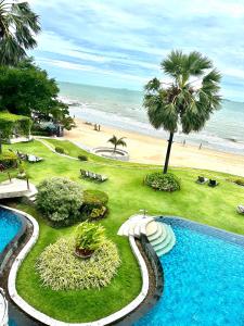 a resort with a swimming pool next to a beach at The Palm Wongamat 22 in North Pattaya