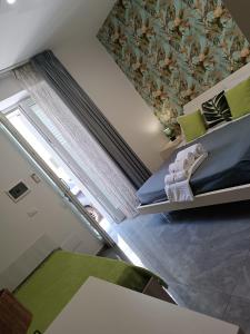a small room with a bed and a window at Bed Nonnonino in Porto Cesareo +189 photos