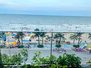 a view of a beach and the ocean from a building at Flamingo Hải Tiến - Căn góc 2 Phòng - View 2 mặt biển in Thanh Hóa