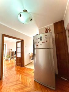 a kitchen with a stainless steel refrigerator in a room at Amar Guest House in Ulaanbaatar +13 photos
