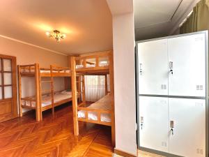 a room with two bunk beds and a closet at Amar Guest House in Ulaanbaatar