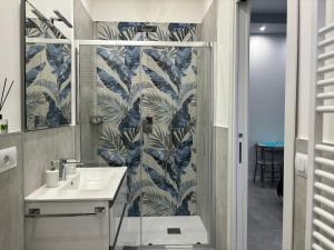 a bathroom with a sink and a mirror at Appartamento Onda in Lido di Ostia