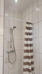a shower with a shower curtain in a bathroom at Room in Shared Apartment-Close to transport in Ballerup