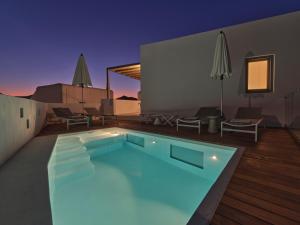 a swimming pool in the middle of a house at Ekos Unique Cycladic Home - Private Pool in Naousa