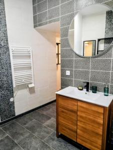 a bathroom with a sink and a mirror at F2 au cœur de Langeais. in Langeais +13 photos