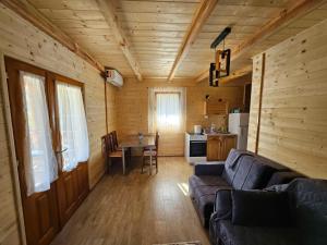 a living room with a couch and a kitchen at Brvnara, Bogutovačka Banja in Banja