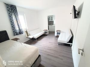 a bedroom with a bed and a living room at FMI33 Next to Airport in Kelsterbach