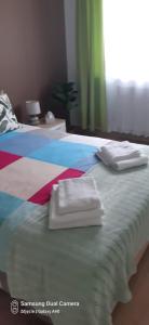 a bedroom with two beds with towels on them at Apartament Białystok in Białystok +11 photos