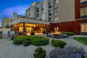 ariott hotel with a patio in front of a building at Homewood Suites by Hilton Billings in Billings