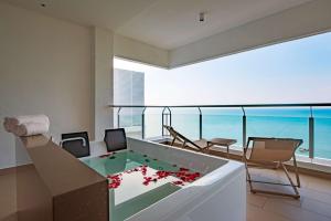 a living room with a view of the ocean at DoubleTree Resort by Hilton Hotel Penang in Batu Ferringhi