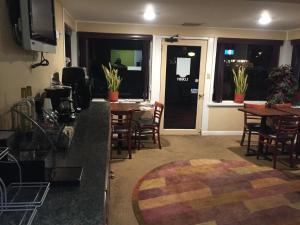 加洛威的住宿－Rest Inn ATLANTIC CITY GALLOWAY，客厅配有桌椅和电视。