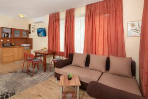 a living room with a couch and a table at Nirvana Guest House in Nesebar