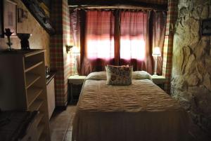 a bedroom with a bed with a pillow on it at La Casa de la Calle Mayor in Castelserás