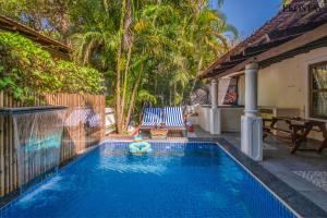 a swimming pool with a toy in the water at EKOSTAY Gold - Oasis Villa in Saligao