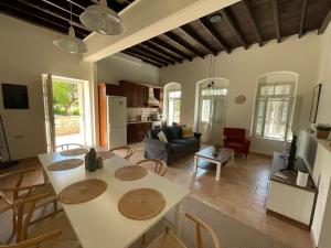 a kitchen and living room with a table and chairs at Portokalia in Mystras