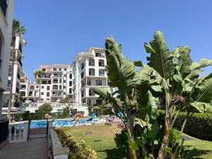 a view of a resort with a pool and buildings at Puerto De La Duquesa in Manilva
