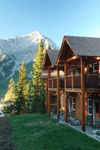 a log cabin with a mountain in the background at Buffalo Mountain Lodge in Banff