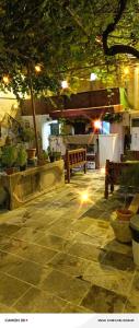 a patio with benches and potted plants at night at Şark Çırağan Konak Boutique Hotel in Urfa