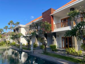 a house with a pool in front of it at Kusuma Life in Kerobokan