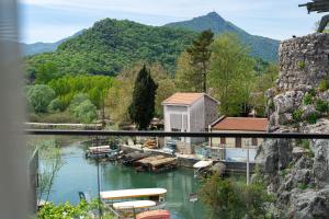 a view of a marina with boats in the water at Hotel De‘Andros Virpazar in Virpazar