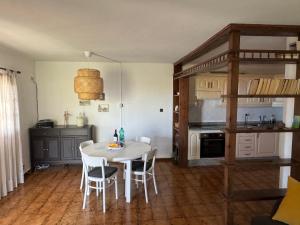 a kitchen with a table and chairs in a room at Finca Gerardo Miramar in La Playa Calera