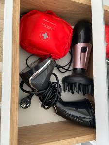 a cupboard with a hair dryer and other appliances at Mimosa Studio in Cluj-Napoca