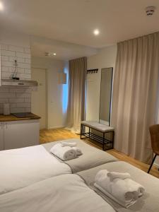 two beds in a bedroom with towels on them at Edsviken Hotell AB in Stockholm