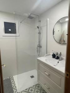 a bathroom with a shower and a sink and a mirror at Urlaub mit Kinder und Freunden in Santa Ponsa