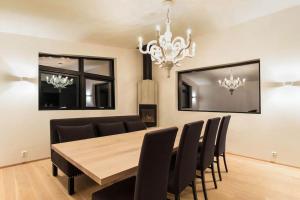 a dining room with a wooden table and black chairs at Villa Holmen The Island - inspiration for the movie The Menu in Gavlen +51 photos