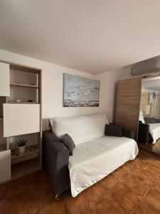 a bedroom with a bed and a couch at AirCon Los Cristianos, Quiet zone, Chipeque appartment in Arona +14 photos