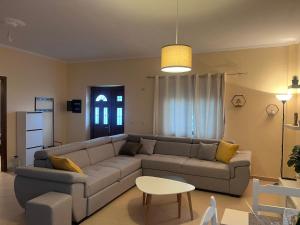 a living room with a couch and a table at Andrew's place in Metogjashta