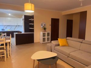 a living room with a couch and a table and a kitchen at Andrew's place in Metogjashta