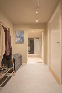 a hallway with a walk in closet and a room at Spacious and elegant apartment in Tromsø