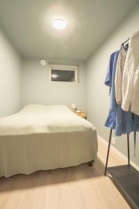 a bedroom with a bed and a clothes rack at Spacious and elegant apartment in Tromsø