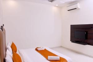 a room with a bed and a tv in it at Nirmal Hotel And Resort in Bareilly +66 photos