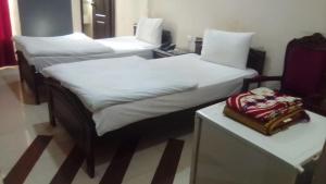 Ένα ή περισσότερα κρεβάτια σε δωμάτιο στο Hotel Grace Inn Multan