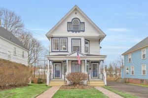 a gray house with a flag in the front yard at Classic West Hartford Center Apartment in West Hartford