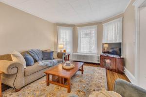 a living room with a couch and a coffee table at Classic West Hartford Center Apartment in West Hartford