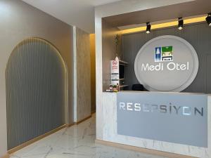 a lobby with a meet old sign on the wall at Medi Otel in Samsun
