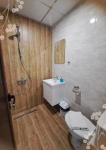 a bathroom with a shower and a toilet and a sink at Къща за гости Мурите in Sapareva Banya +51 photos
